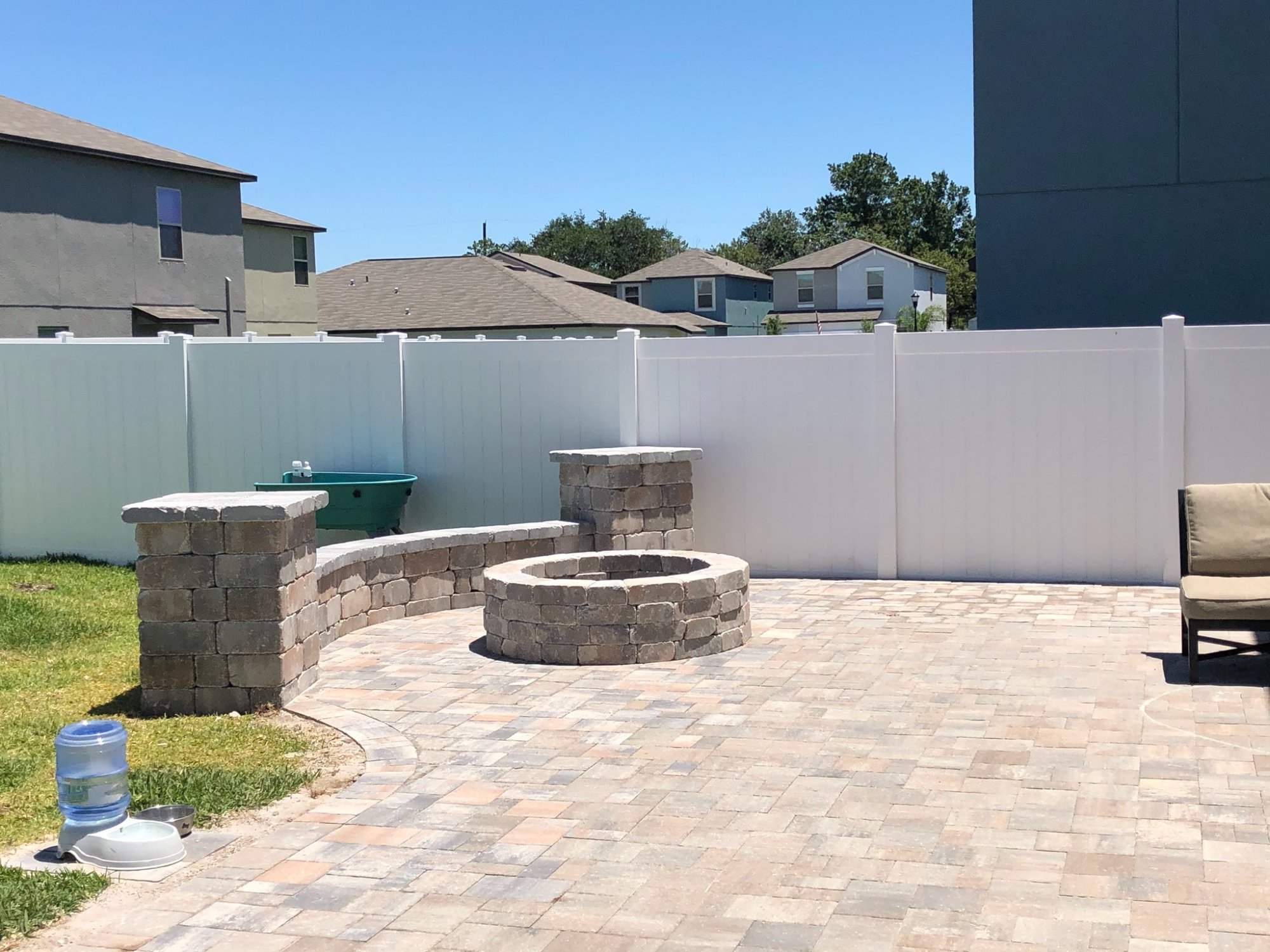 Paver patio with fire pit and seating wall